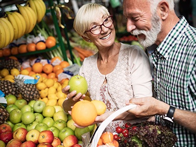 An older couple buying healthy foods from a super market