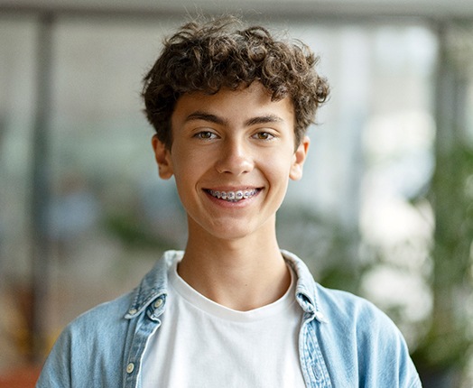 a teen with braces smiling