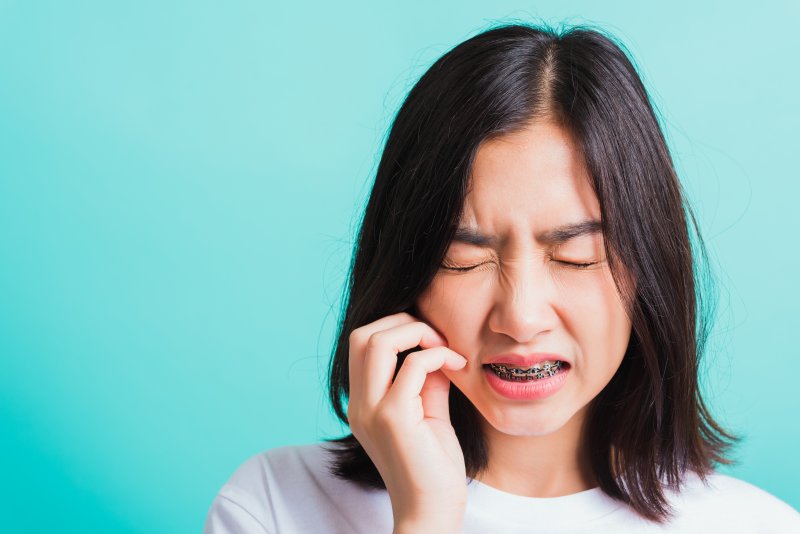 An unhappy woman suffering common problems with braces